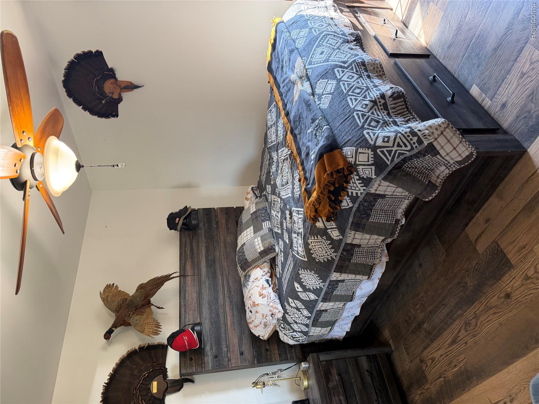 6860 Grand River Road Bancroft, MI 48414 - Photo 10 of 31 Bedroom featuring dark wood-style floors and ceiling fan