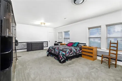 a bedroom with a bed and a cabinets