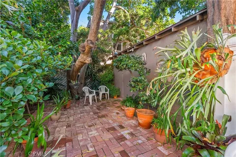 a view of a chair and tables in the patio