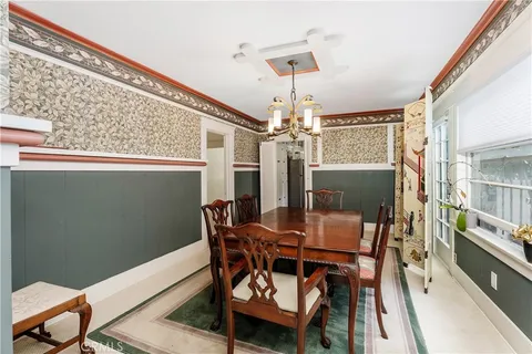 a view of a dining room with furniture and a chandelier