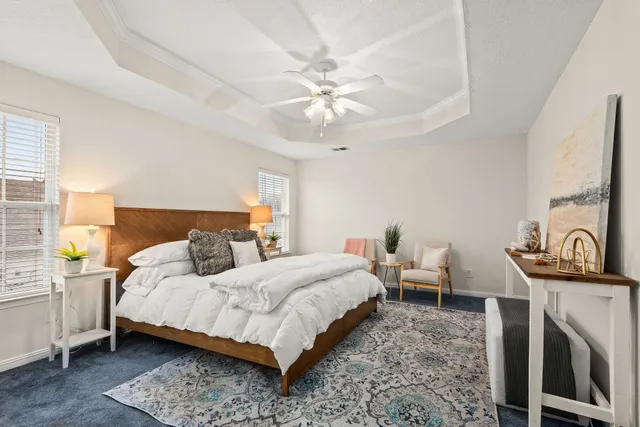 a bedroom with a bed and a chandelier