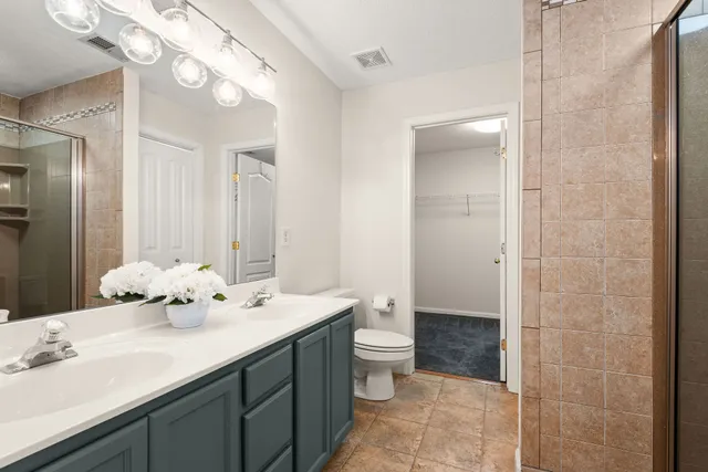 a bathroom with a double vanity sink and a mirror