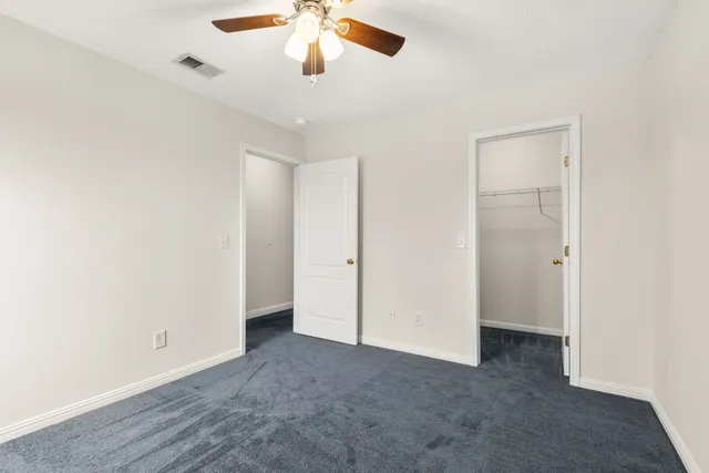 an empty room with a empty space and a ceiling fan