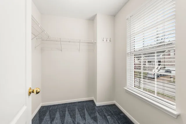 a view of small space with wooden floor and a window