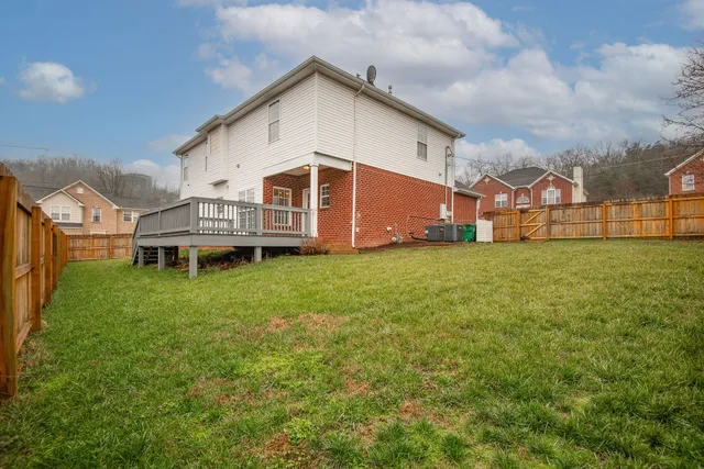 a view of a house with a yard and sitting area