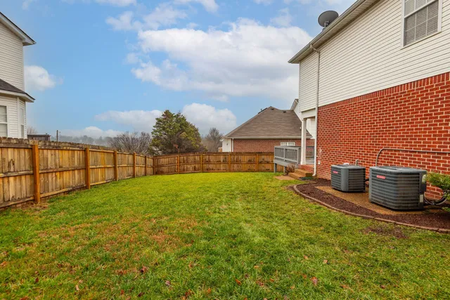a view of a backyard with sitting area