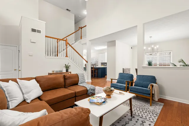 a living room with furniture and wooden floor