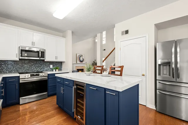 a kitchen with kitchen island granite countertop a sink stove and refrigerator