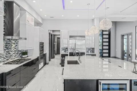 a large kitchen with granite countertop a lot of counter space and stainless steel appliances