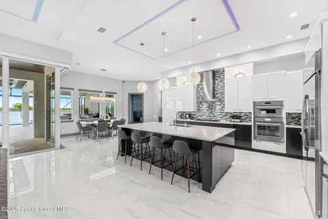 a large kitchen with lots of counter space and furniture