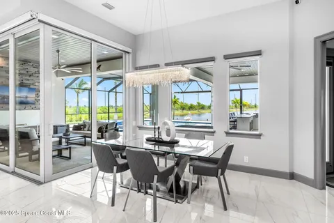 a view of a dining room with furniture large windows and wooden floor