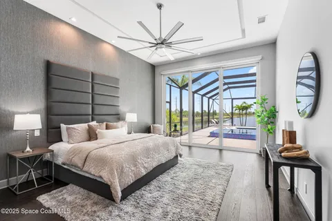 a bedroom with a large bed and a chandelier