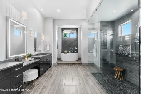 a bathroom with a granite countertop sink a toilet a mirror and shower