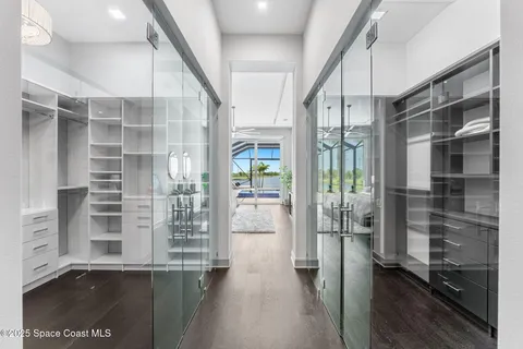 a view of walk in closet with empty racks