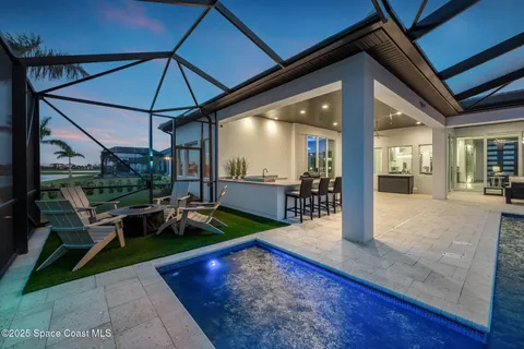 a view of a patio with table and chairs under an umbrella