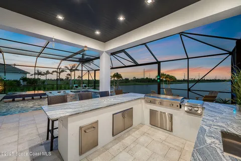 a view of a patio with a table and chairs under an umbrella