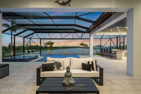 a outdoor space with the couches and dining table with the garden view