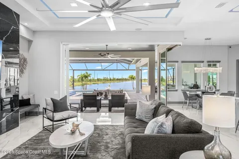 a living room with furniture dining area and a large window