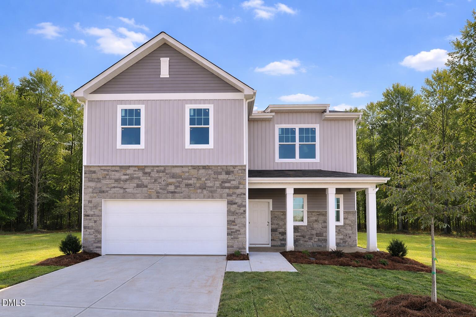 2577 Quarry Road Rolesville, NC 27571 - Photo 1 of 38 a front view of a house with a yard and trees