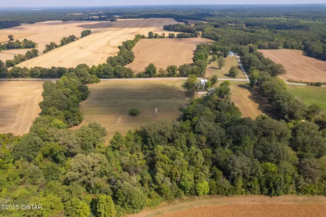 an aerial view of ocean with residential house and outdoor space