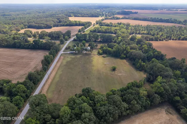 an aerial view of residential houses with outdoor space and river