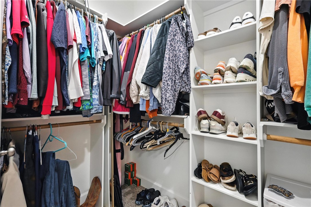 2862 Messenger Way Bryan, TX 77803 - Photo 13 of 22 a view of walk in closet with clothes and shoes