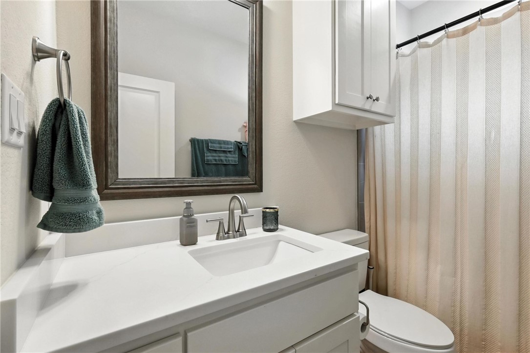 2862 Messenger Way Bryan, TX 77803 - Photo 16 of 22 a bathroom with a sink vanity mirror and toilet