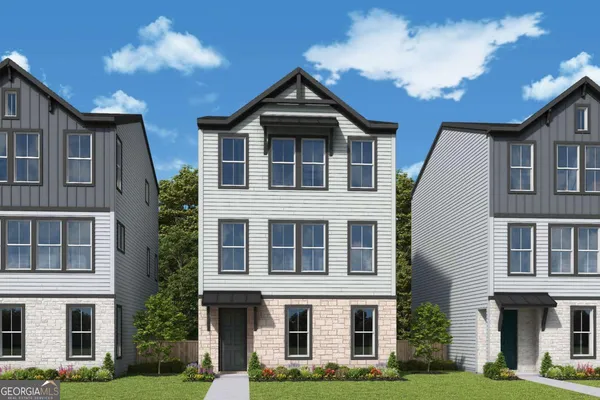 a front view of a residential apartment building with a yard