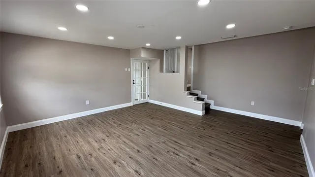 a view of a room with wooden floor