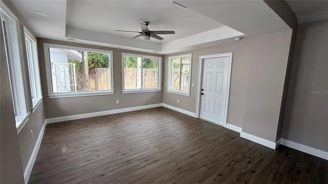 wooden floor in an empty room with a window