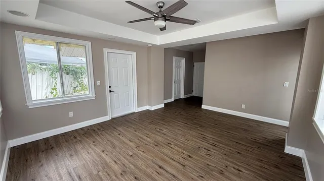 wooden floor in an empty room with a window