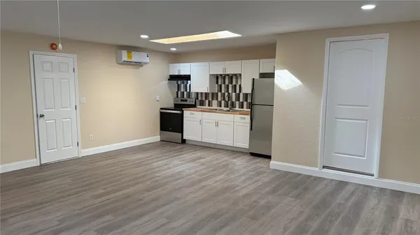 a kitchen with stainless steel appliances a refrigerator and cabinets