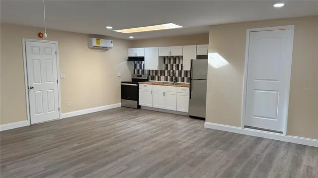 a kitchen with stainless steel appliances a refrigerator and cabinets