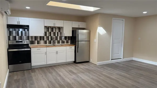 an empty room with wooden floor and a window