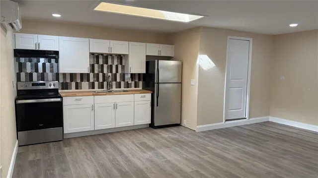 an empty room with wooden floor and a window