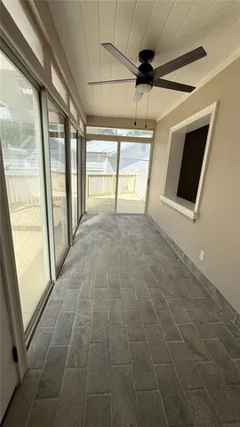 a view of a livingroom with a ceiling fan and window