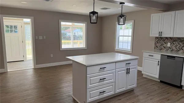 a kitchen that has a lot of cabinets in it