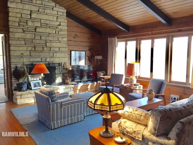 6495 West Blackjack Road Hanover, IL 61041 - Photo 12 of 21 a living room with furniture a fireplace and large windows