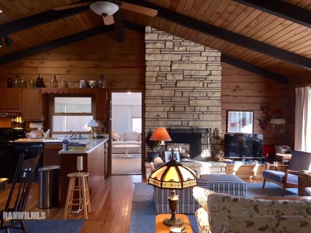 6495 West Blackjack Road Hanover, IL 61041 - Photo 8 of 21 a living room with furniture a fireplace and wooden floor