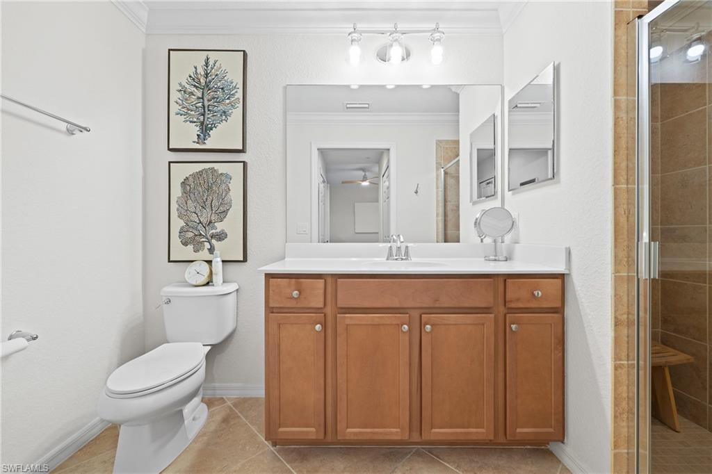 9715 Acqua Court, Unit 116 Naples, FL 34113 - Photo 13 of 43 a bathroom with a toilet sink and mirror