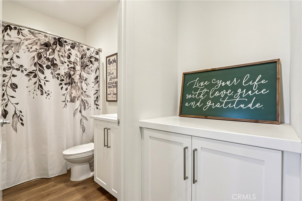 35293 Funk Way Beaumont, CA 92223 - Photo 20 of 70 a view of a bathroom with a toilet and a shower curtain