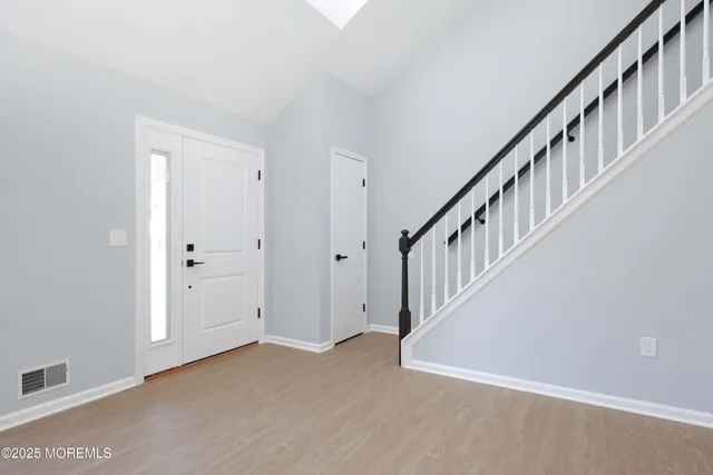 a view of an entryway with wooden floor