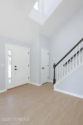 a view of an empty room with chandelier