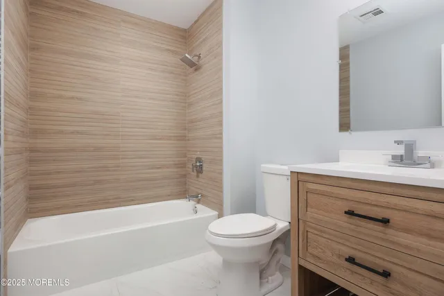 a bathroom with a sink a toilet and bathtub