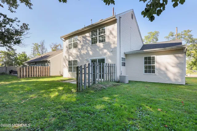 a view of a house with a yard and deck