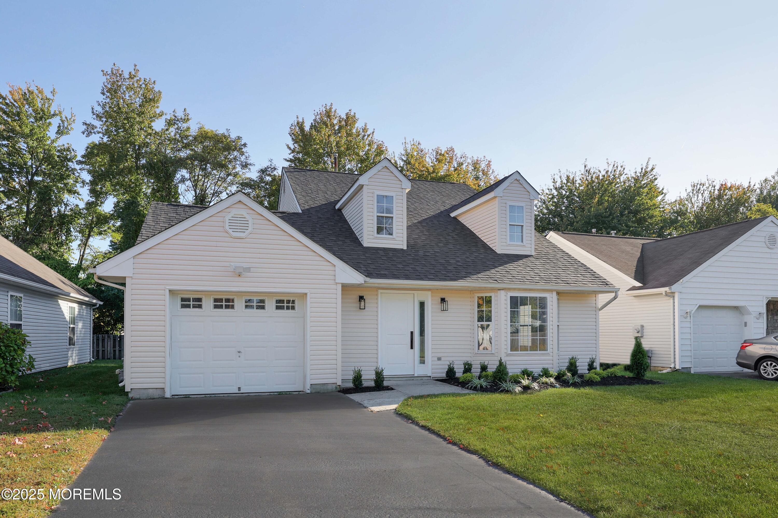 4 Ellison Court Union Beach, NJ 07735 - Photo 30 of 35 a front view of a house with a yard and garage