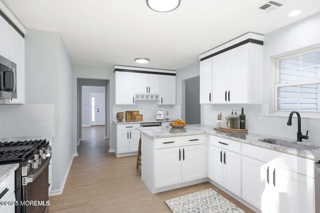 a kitchen with a sink stove and cabinets