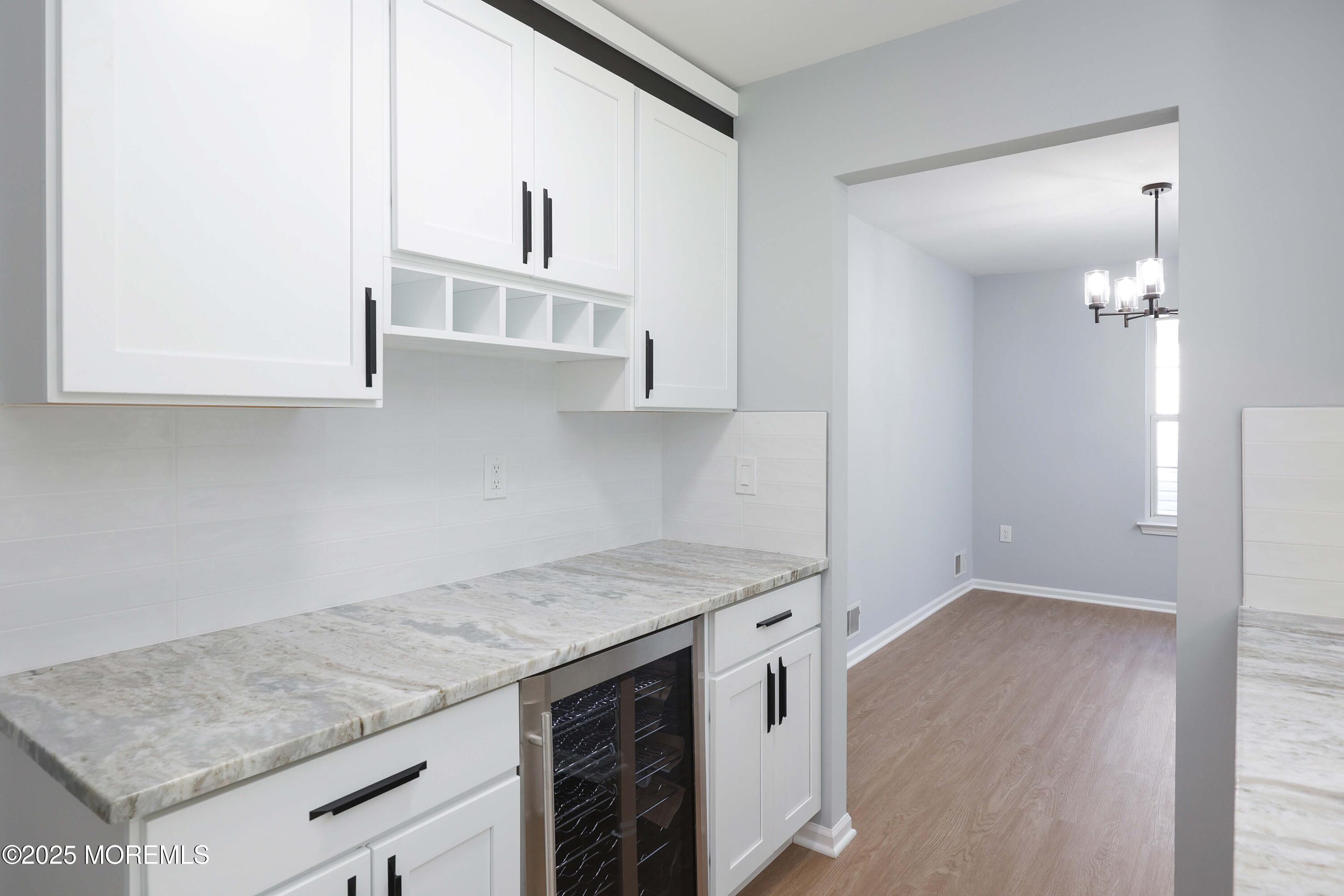 4 Ellison Court Union Beach, NJ 07735 - Photo 5 of 35 an empty kitchen with granite countertop a stove and a sink