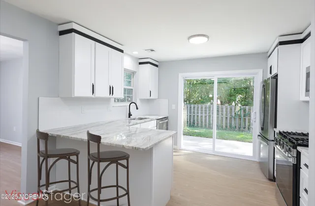 a kitchen with kitchen island a sink and a large window