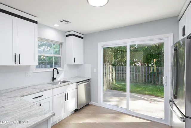 a kitchen with a sink and large window